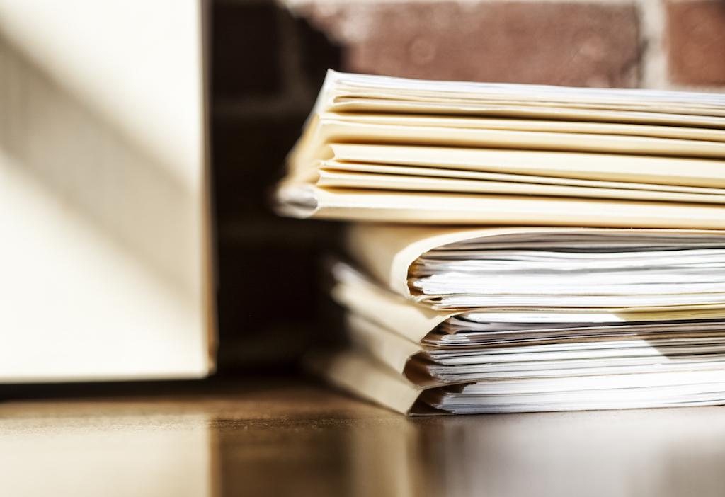 Close-up of signed Court of Protection application and supporting documents